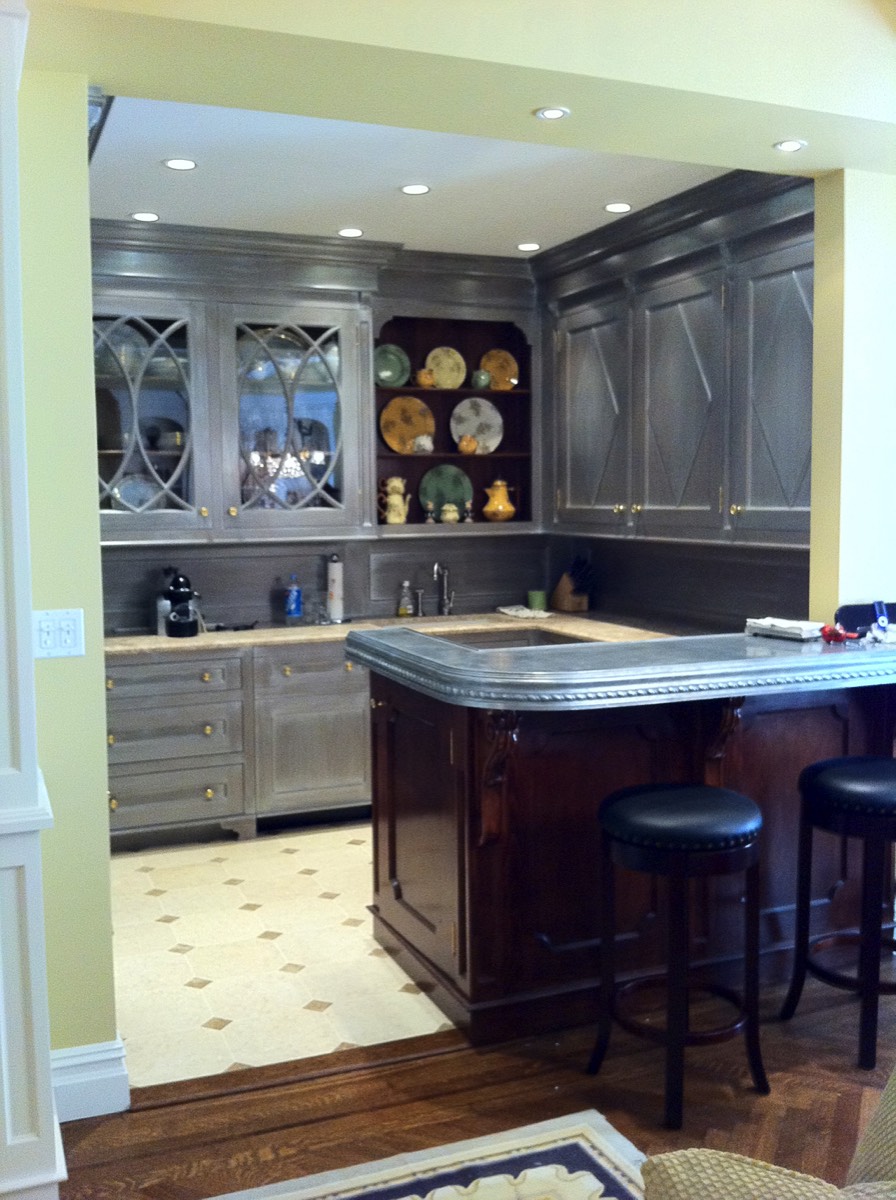 Stained island bar connects to the main living room.